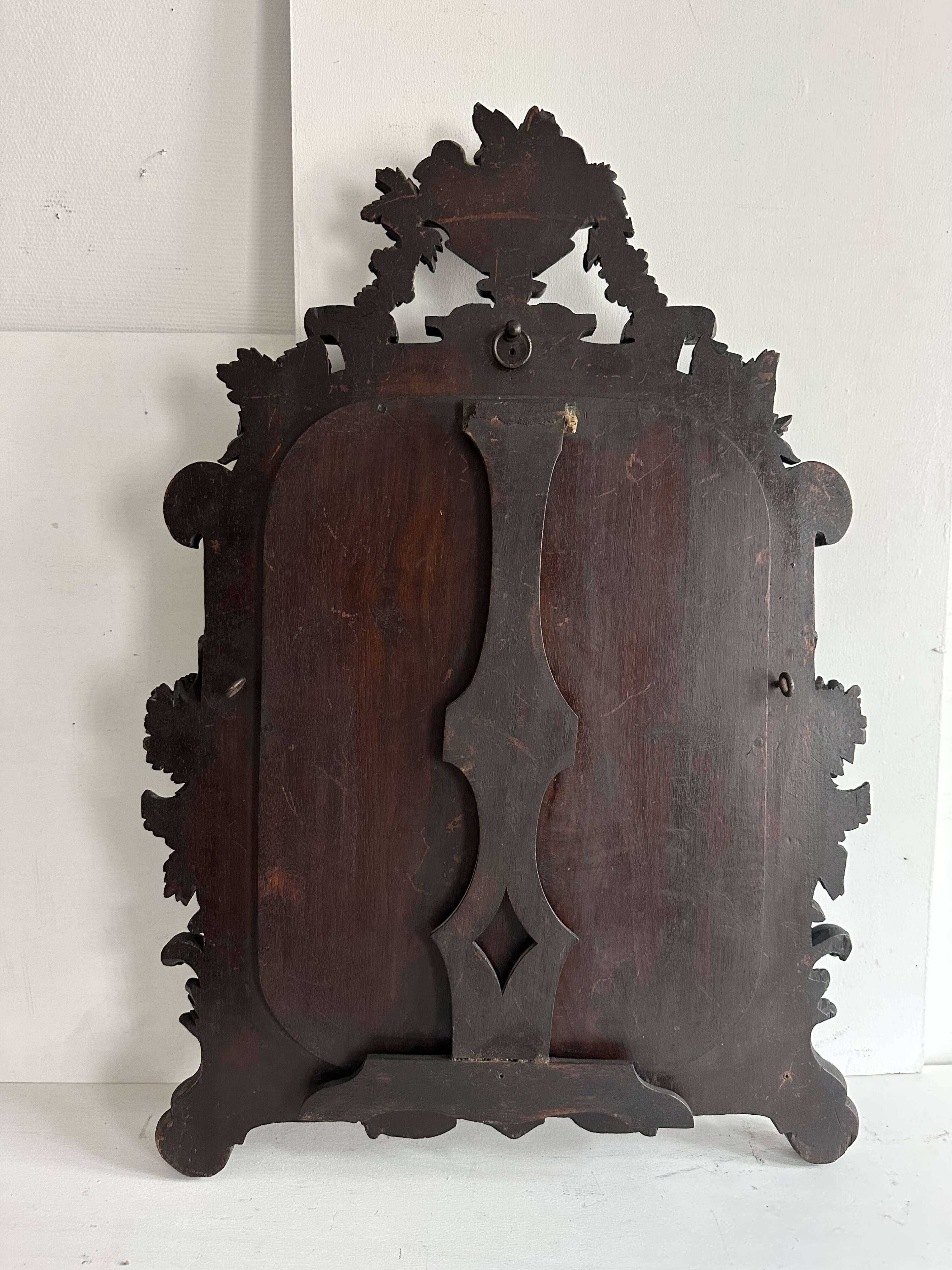 Napoleon III mirror in carved blackened wood, 19th century