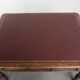 Antique English writing desk from the 19th century with a red leather top
