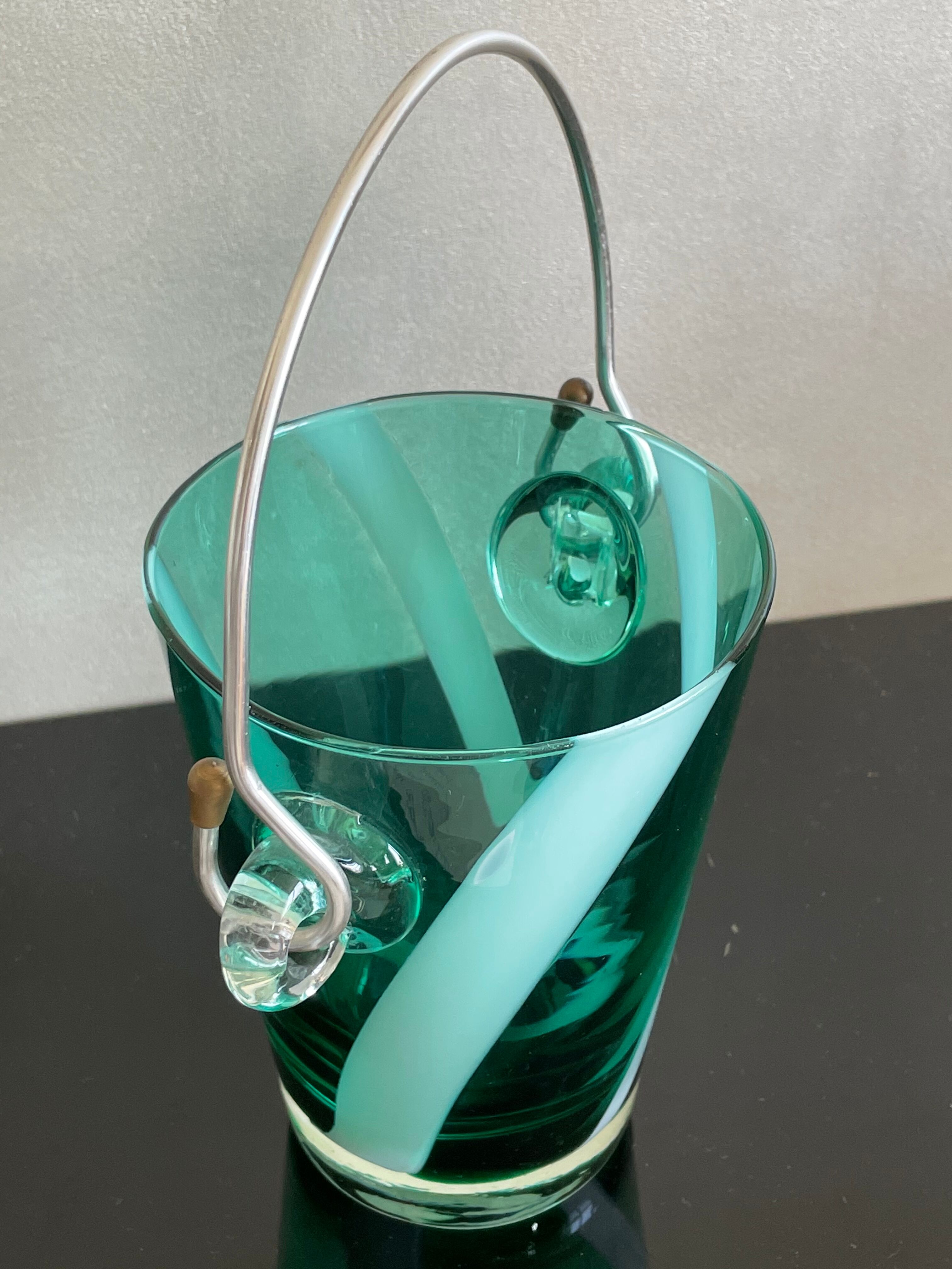 Bucket with ice cubes colored green glass