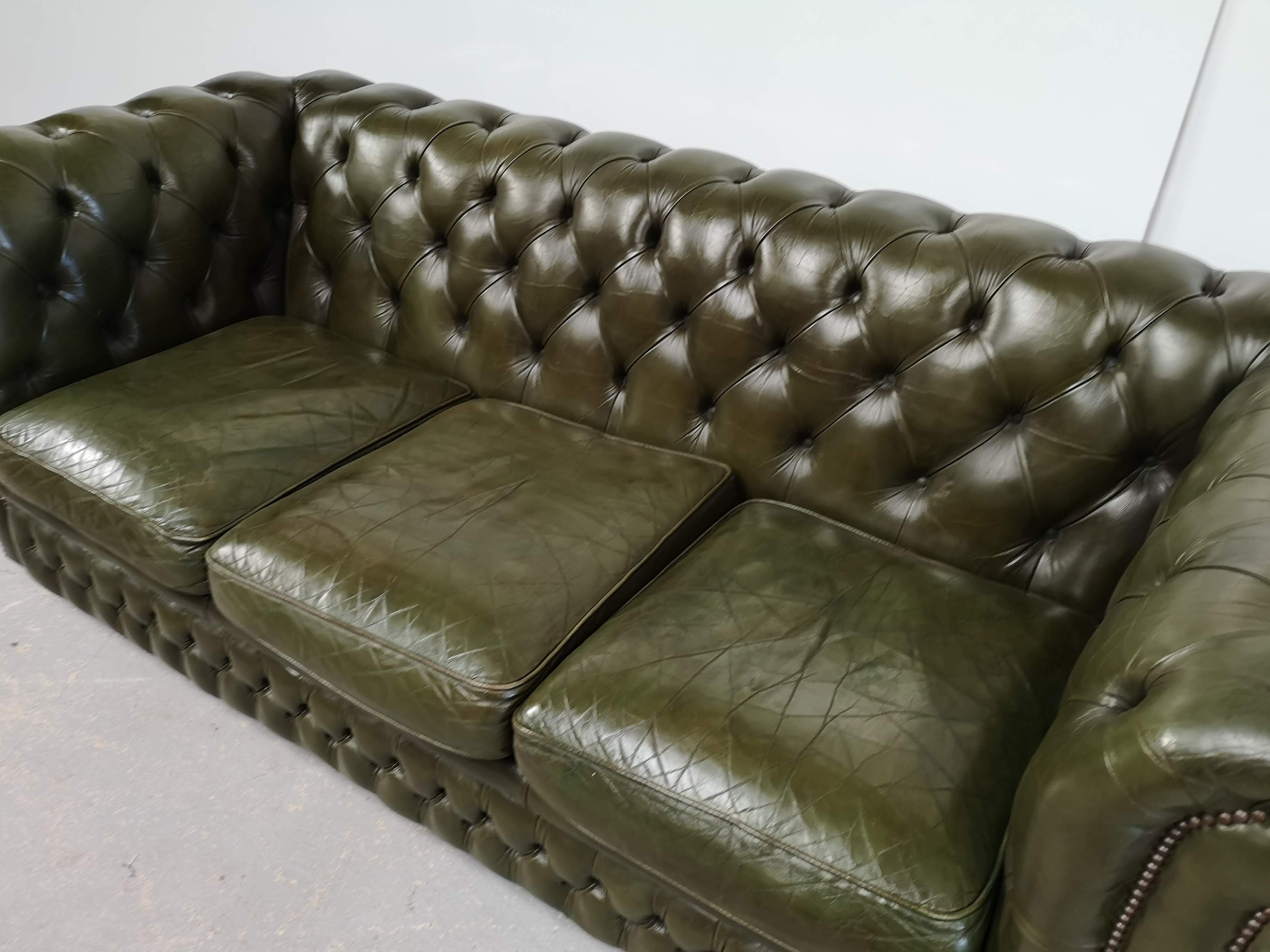 Three-seater green leather Chesterfield sofa