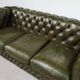 Three-seater green leather Chesterfield sofa