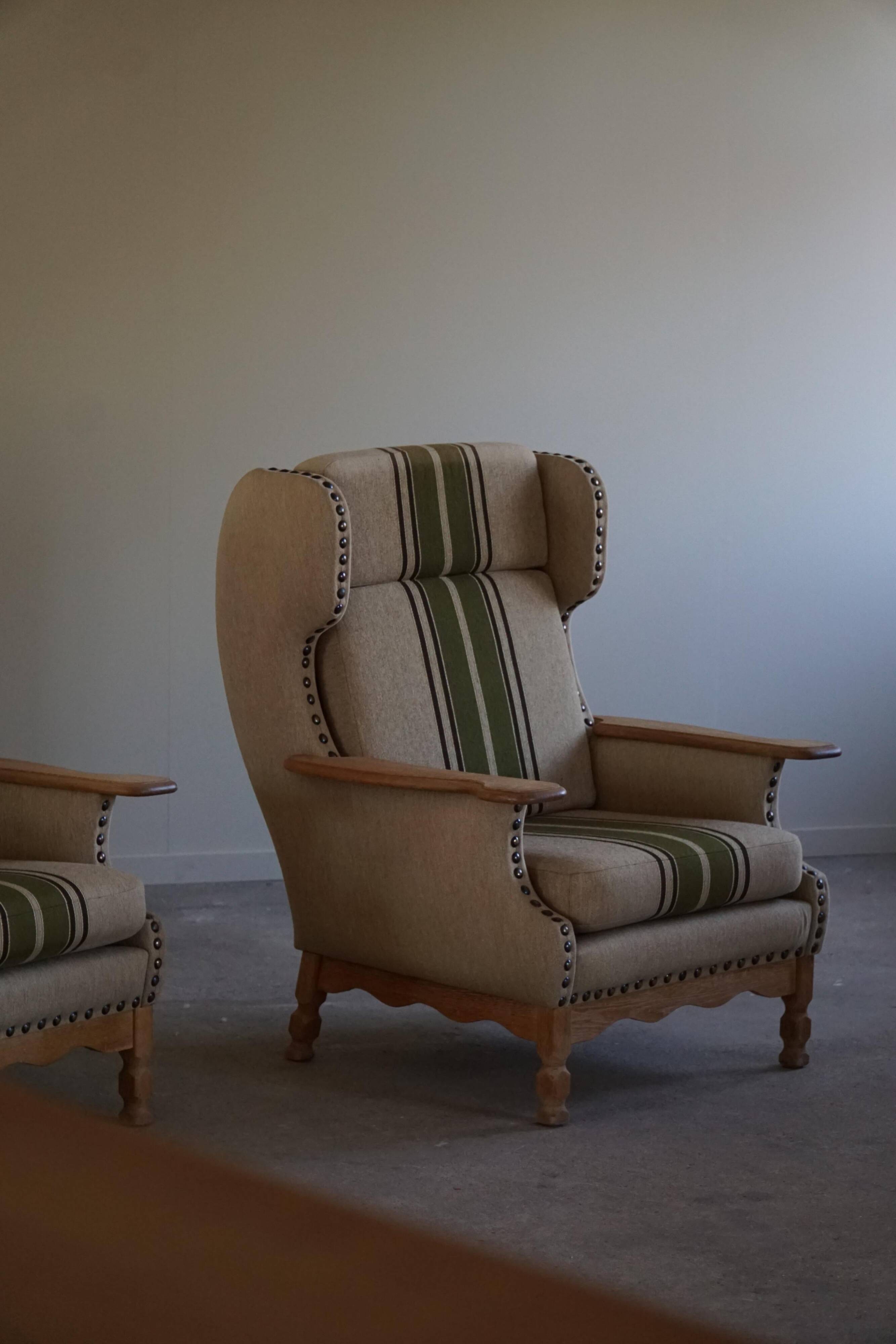 Pair of high-back lounge chairs in modern Danish style in the manner of Henning Kjærnulf, 1960s.