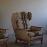 Pair of high-back lounge chairs in modern Danish style in the manner of Henning Kjærnulf, 1960s.