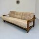 Old 3-seater sofa in solid wood, Maison Regain design, from the 70s.