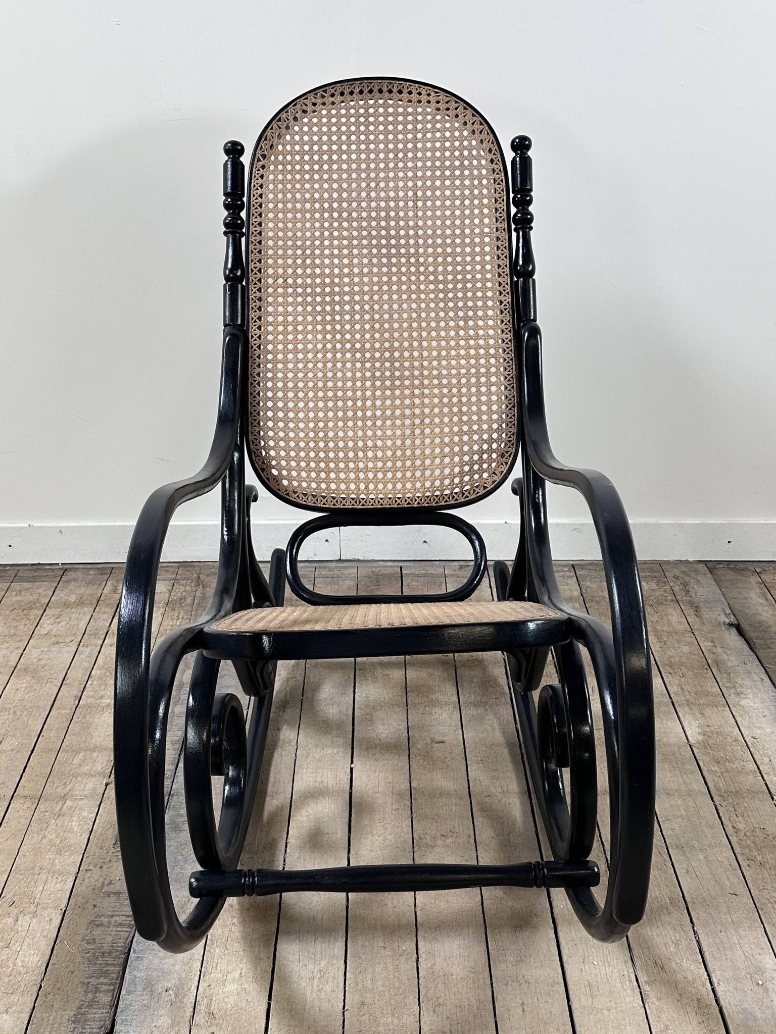 Rocking chair in blackened curved wood and cane, 1900s