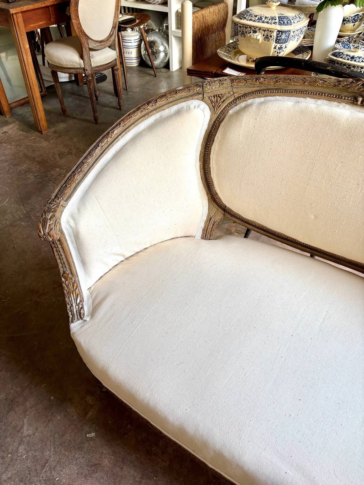 Two-seater basket bench in carved wood and beige mixed fabric, 18th century.