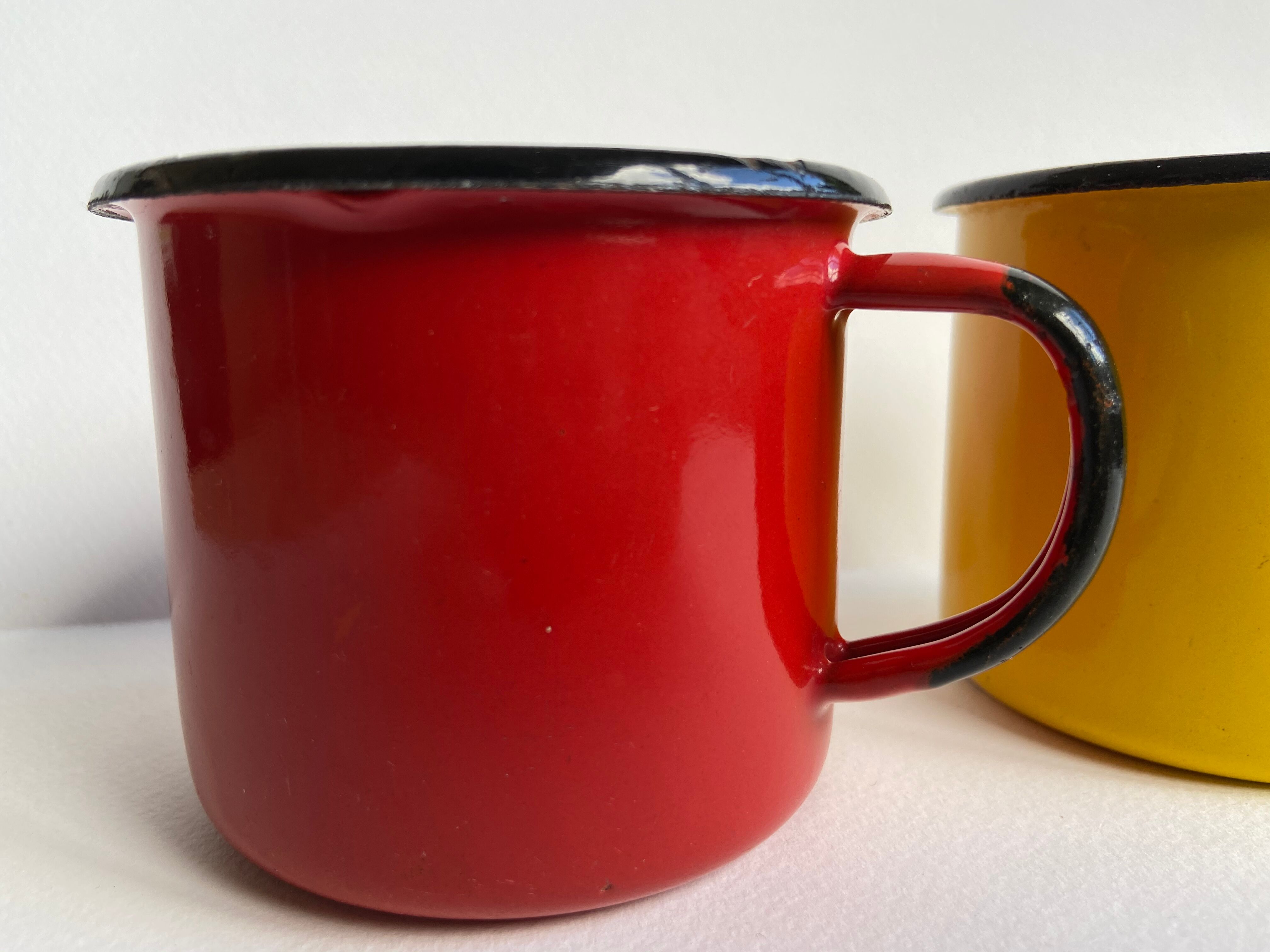 Pair of enamelled sheet metal mugs