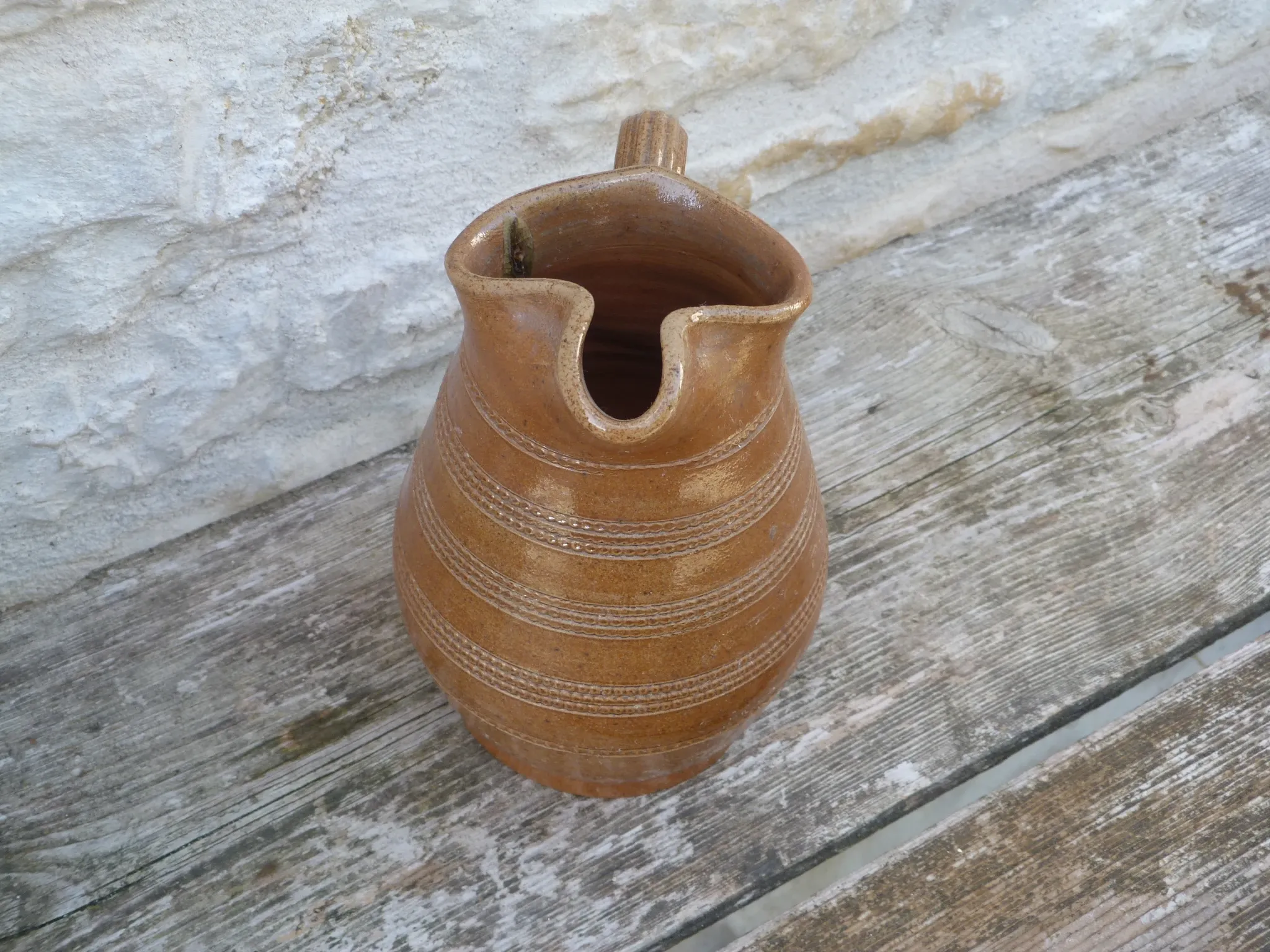 Old stoneware wine jug with patterns