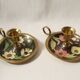 Set of 2 round golden metal candle holders and floral patterns