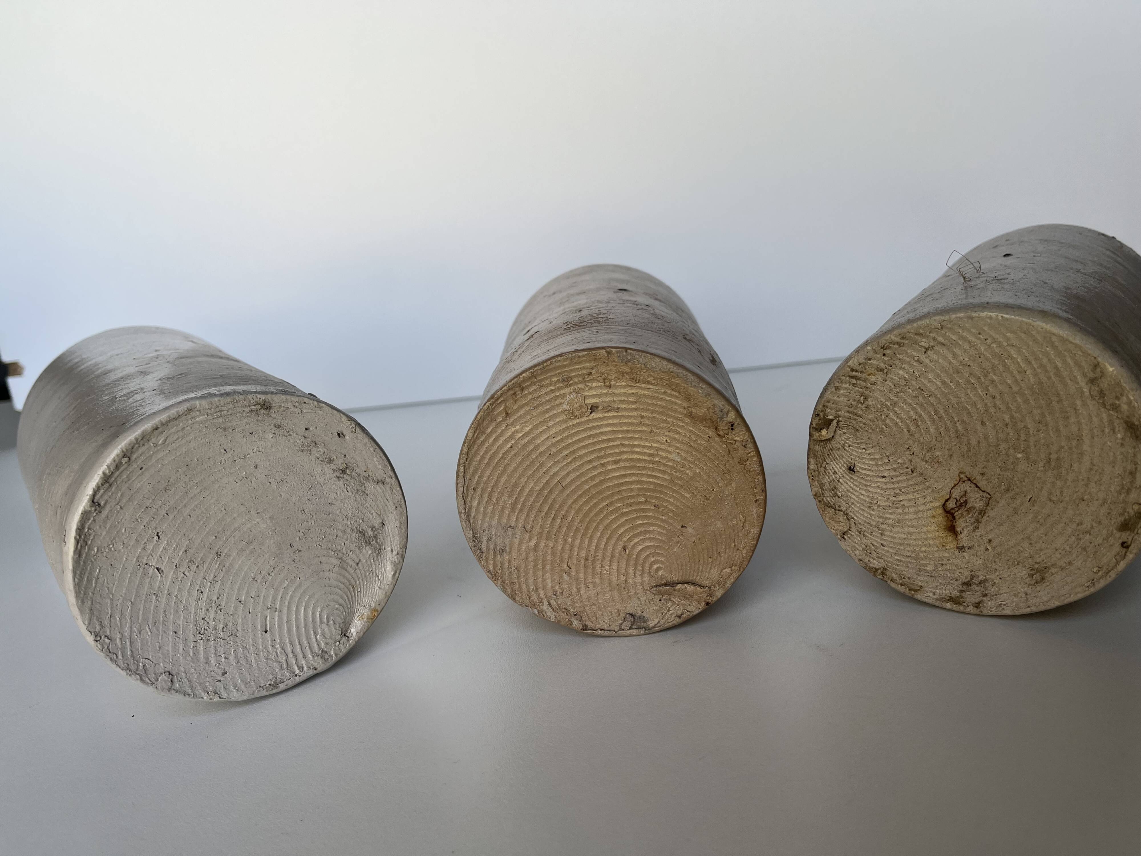 Trio of antique matte stoneware bottles