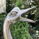 Old vintage lamp representing a duck in silver metal with wooden base