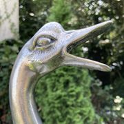 Old vintage lamp representing a duck in silver metal with wooden base