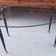 Table basse 1950 ovale en verre acier et laiton
