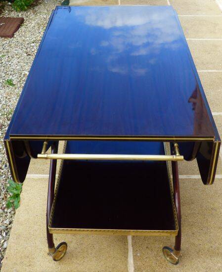 Chic serving table on wheels from the 60s with brass decorations and two shelves.