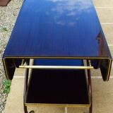 Chic serving table on wheels from the 60s with brass decorations and two shelves.