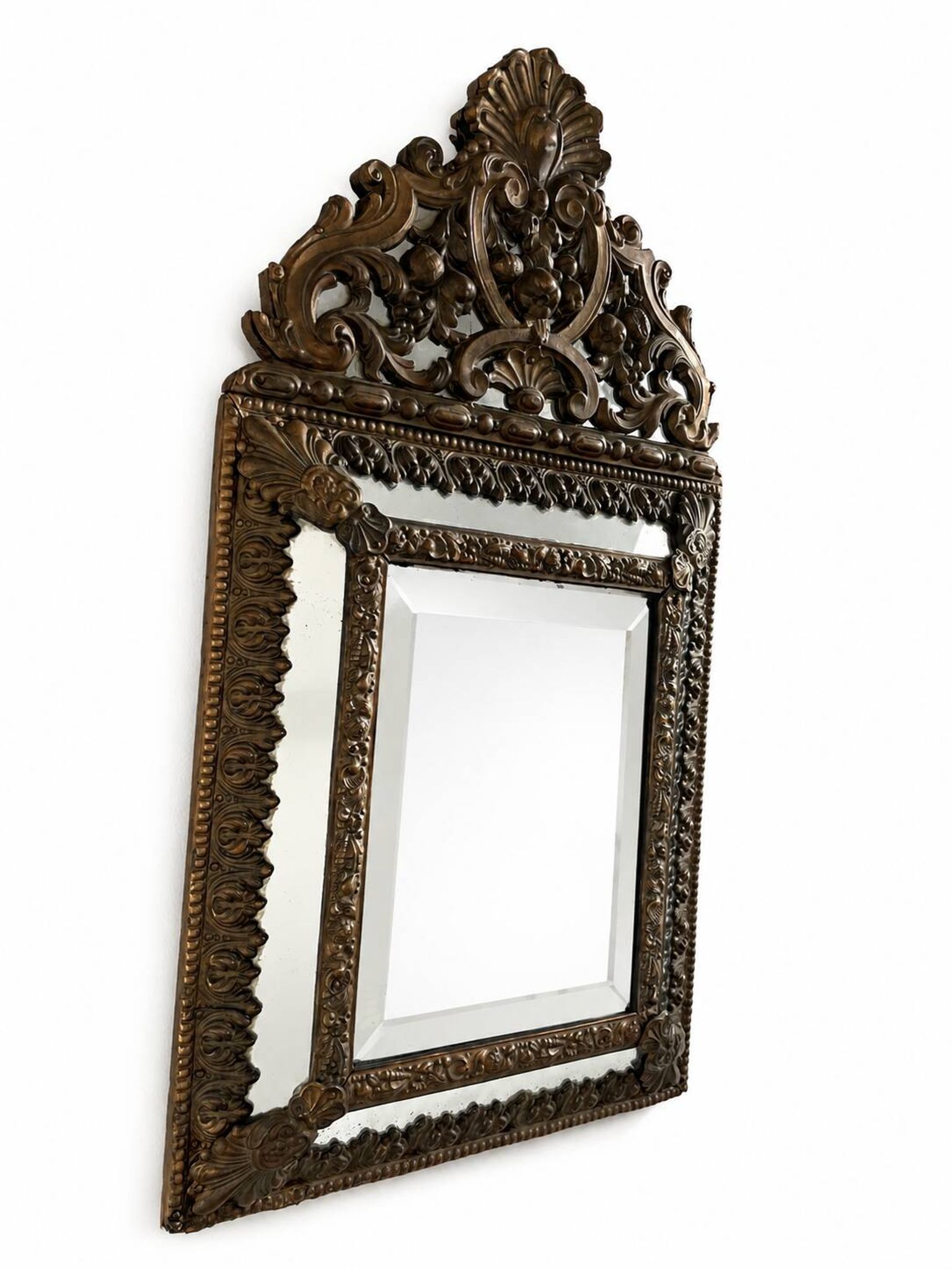 Small mirror with brass parcloses in repoussé style Louis XIV, late 19th century.