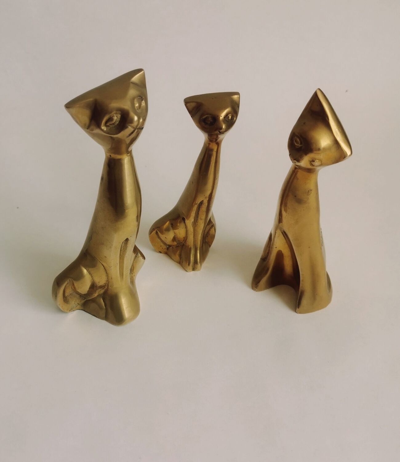 Trio of cats in gilded brass