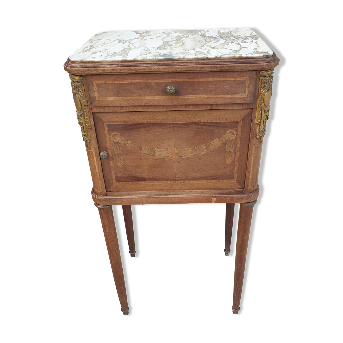 Old wooden bedside table on marble top