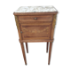 Old wooden bedside table on marble top