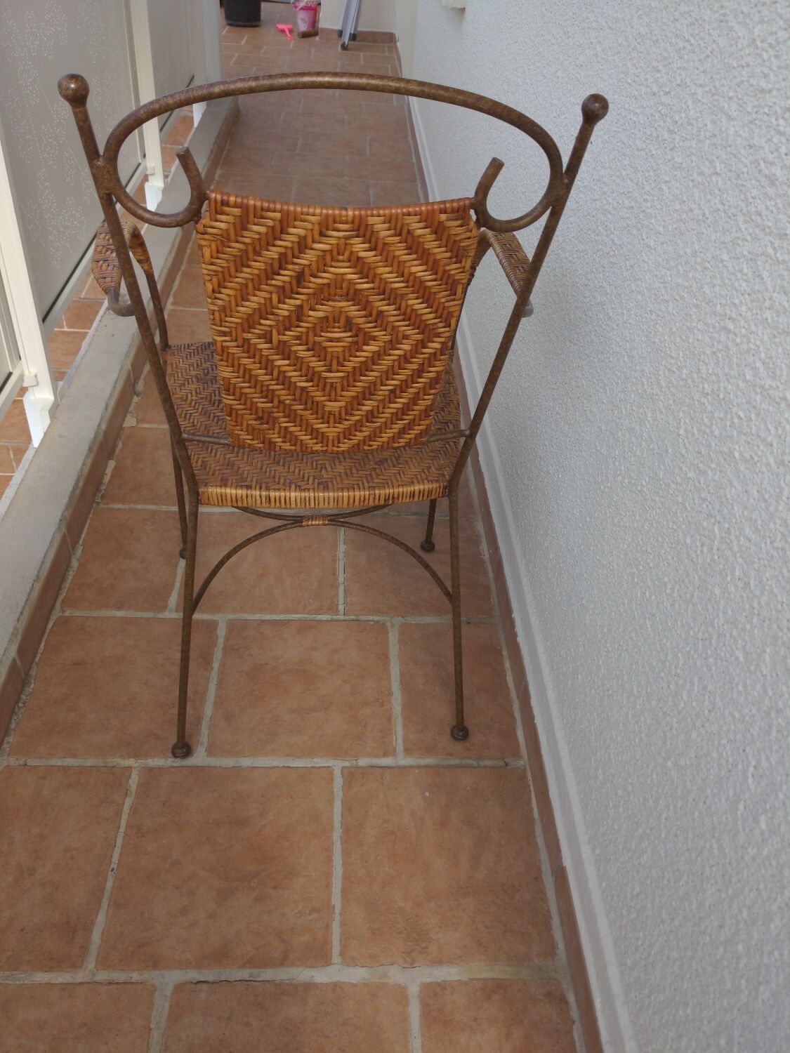 Wicker armchair and wrought iron