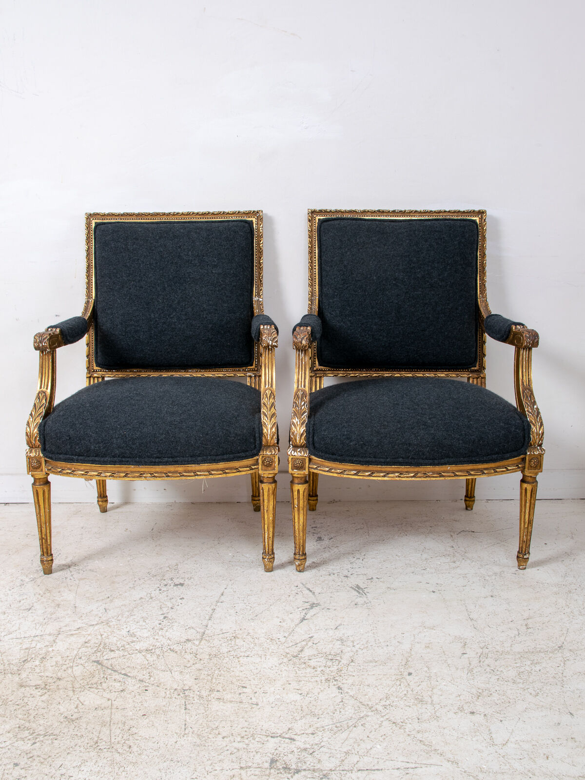 Pair of 19th century Louis XVI gilt armchairs newly re upholstered in holland and sherry fabric