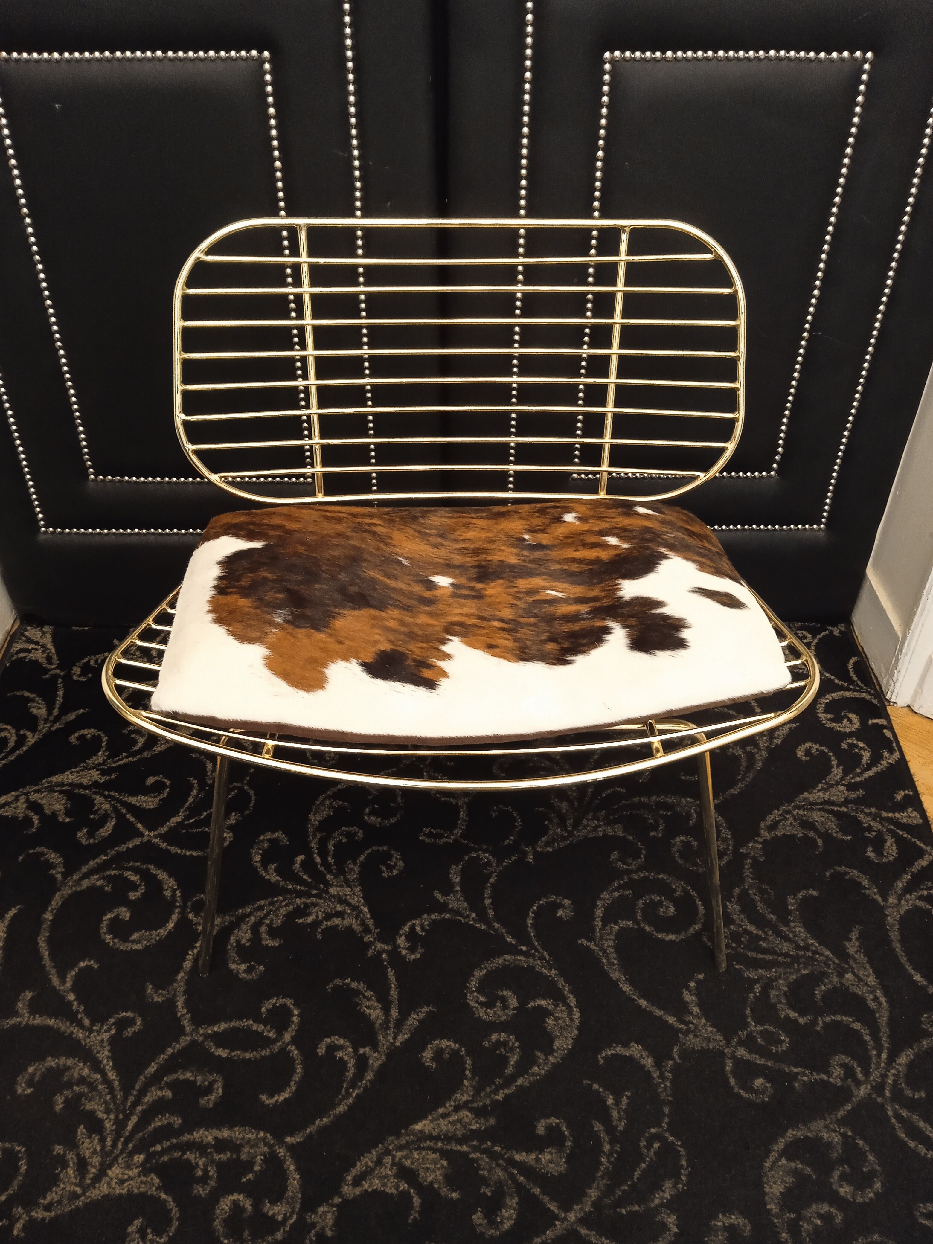 Designer gold wire armchair with cowhide cushion
