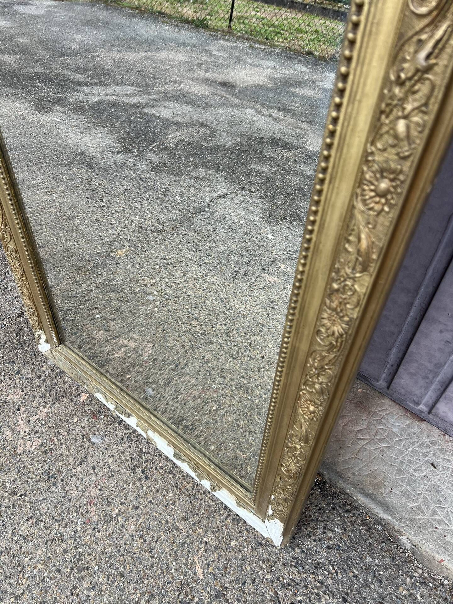Large Louis Philippe mirror in carved gilded wood with mercury glass.