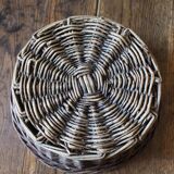 Round wicker basket with a patina