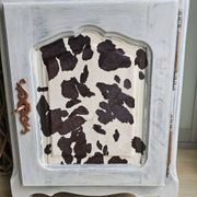 Two solid wood bedside tables with calfskin decoration.