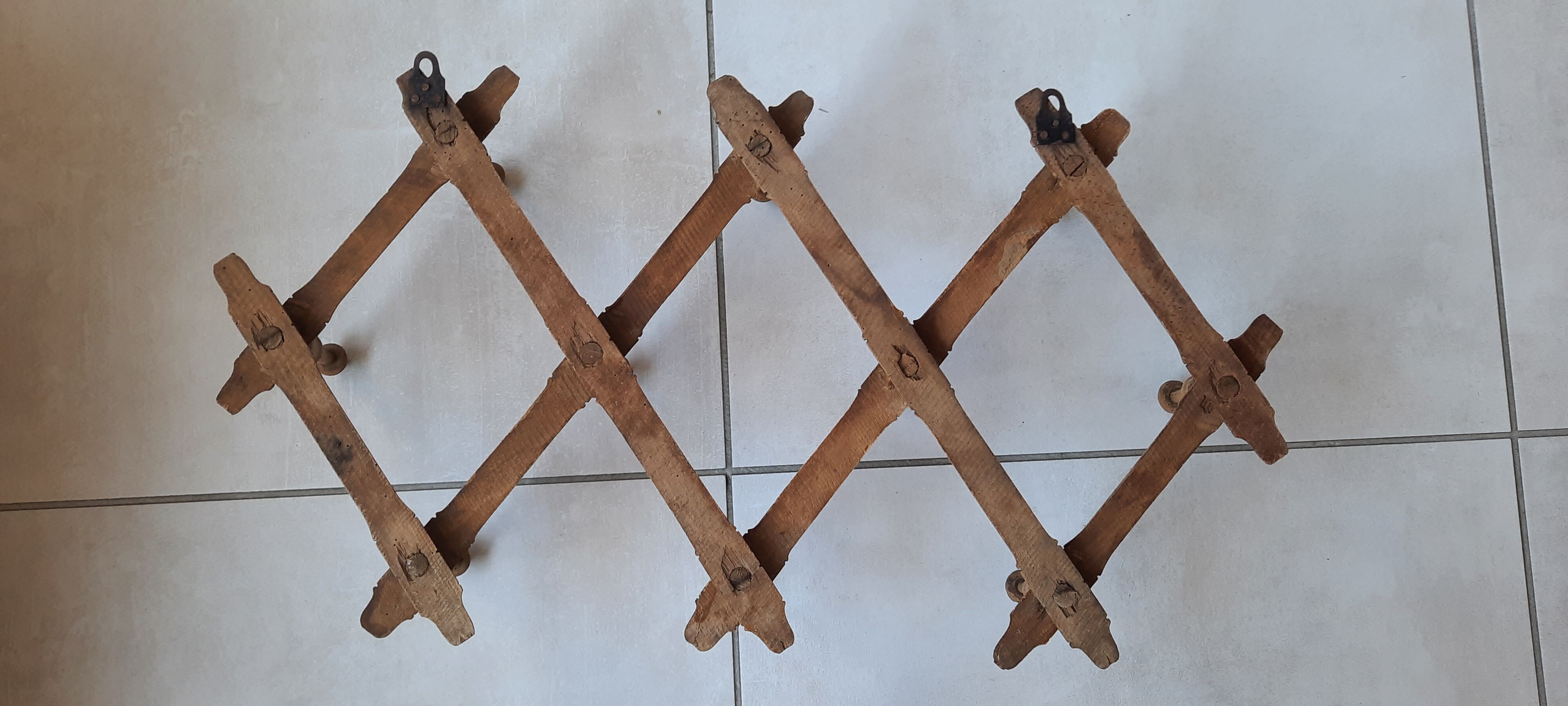 Old accordion wall coat rack
