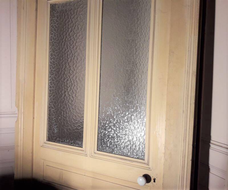 Large glazed door and its old glazed transom.