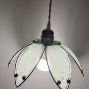 Glass flower rimmed with brass