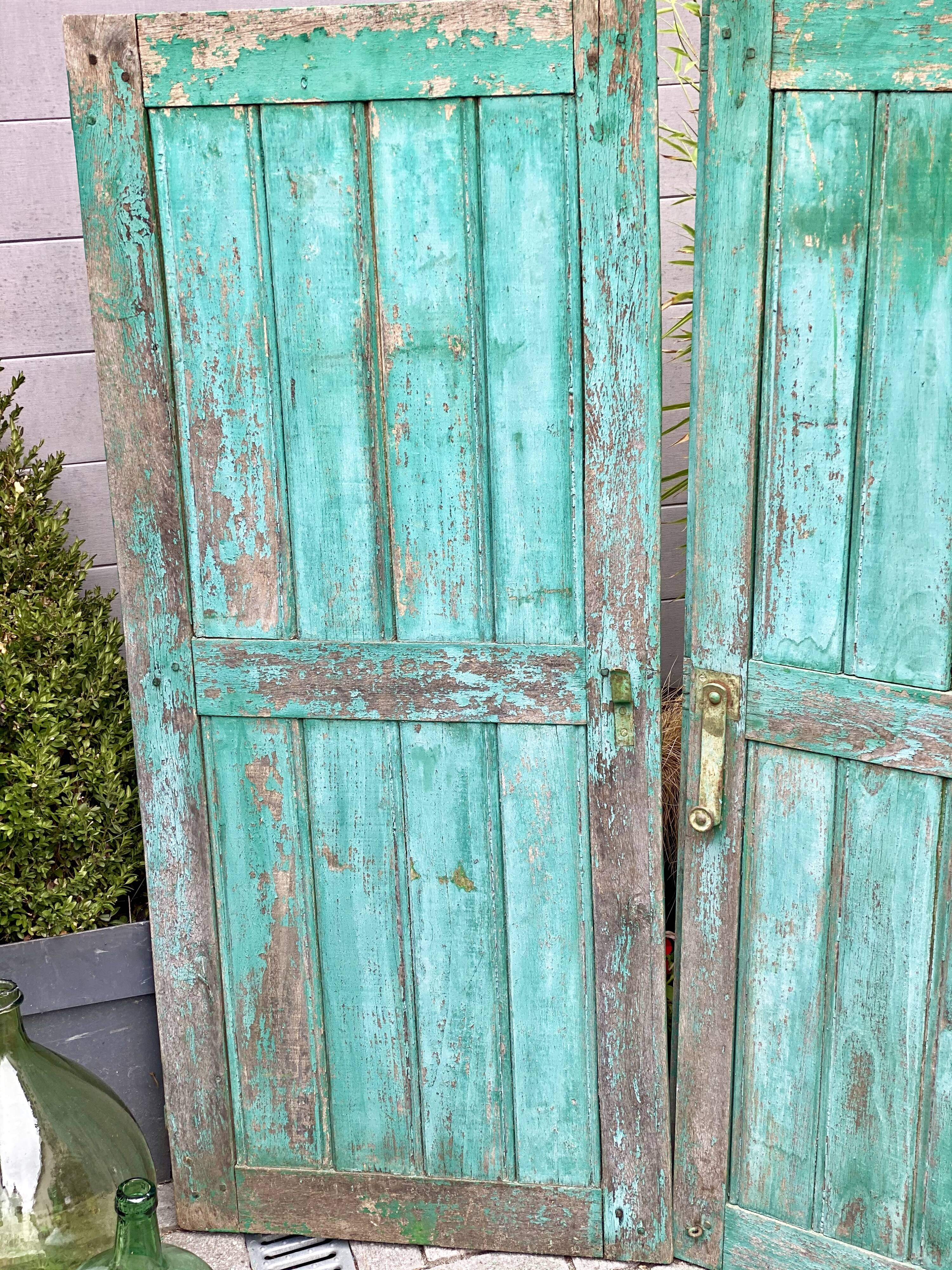 Pair of old wooden shutters green mint color