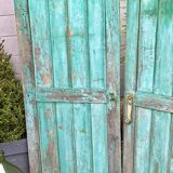 Pair of old wooden shutters green mint color