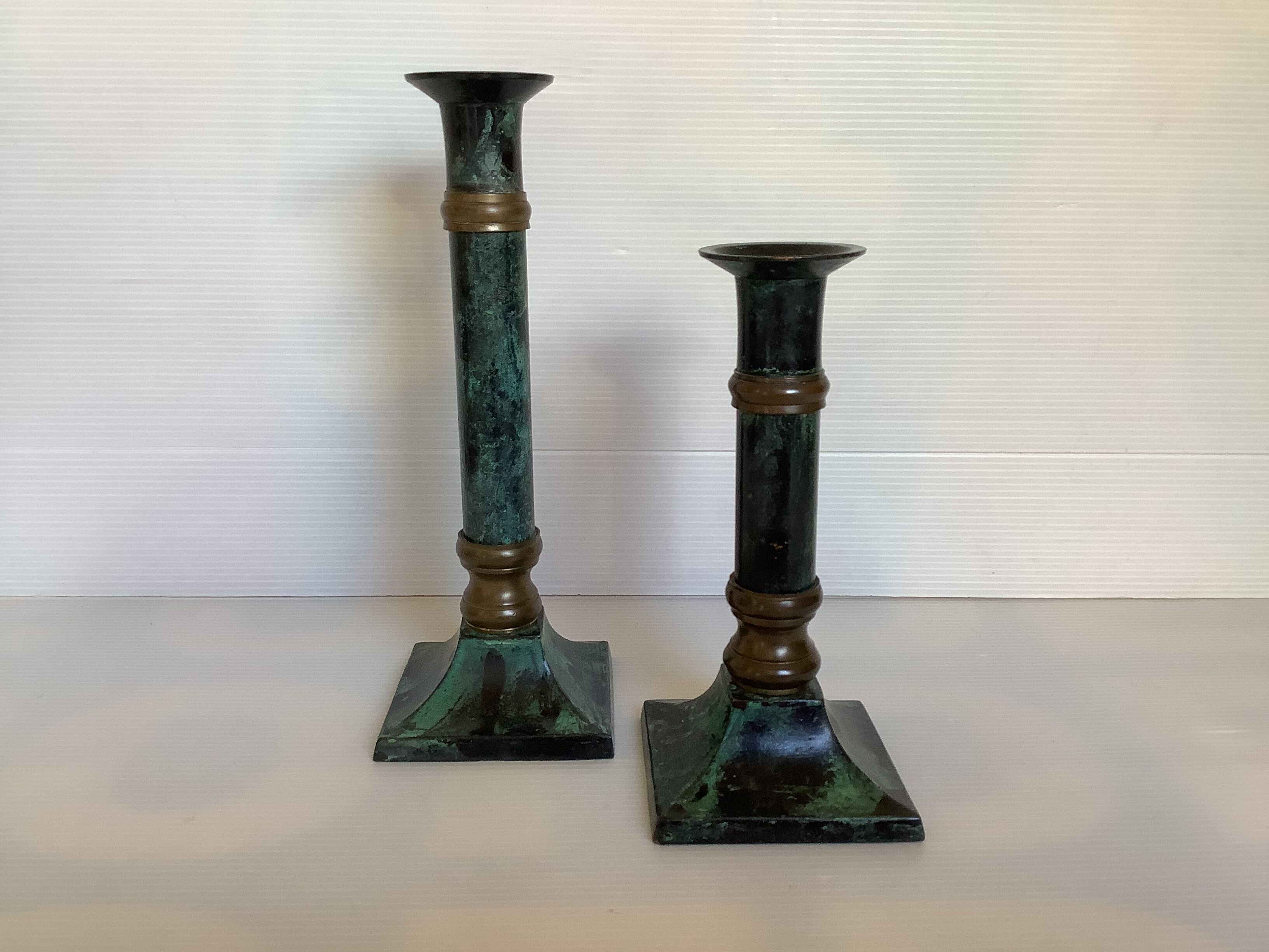 Pair of green patinated brass candlesticks