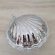 Shell-shaped butter dish in stainless steel and white glass bowl.