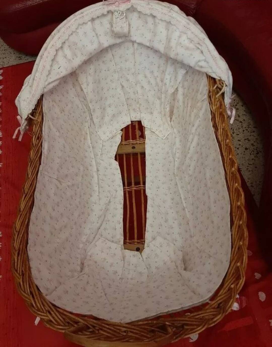 Vintage wicker cradle on wheels from the 1970s.