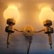 Three Empire style golden torch wall sconces