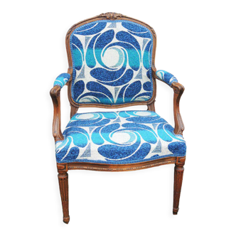Old armchair upholstered Louis XV style