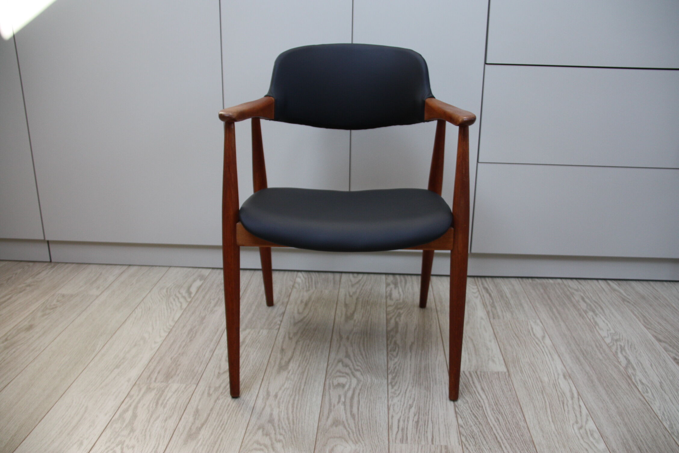 Vintage armchair in teak and black leather model Casina 60s