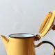 Old coffee maker in yellow enameled sheet metal - olive decor