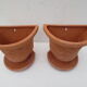 Duo of decorated terracotta wall flowerpots