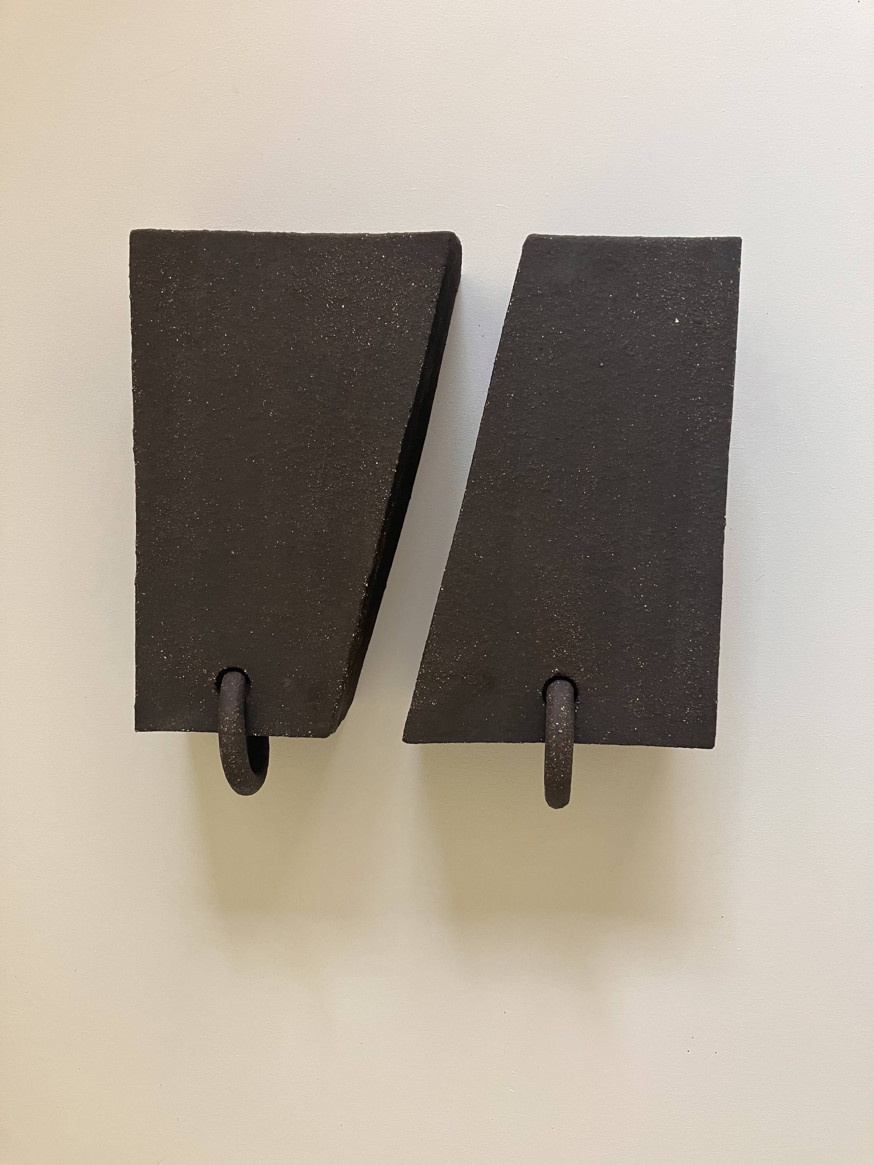 Pair of black stoneware graphic wall lights with handmade ring.