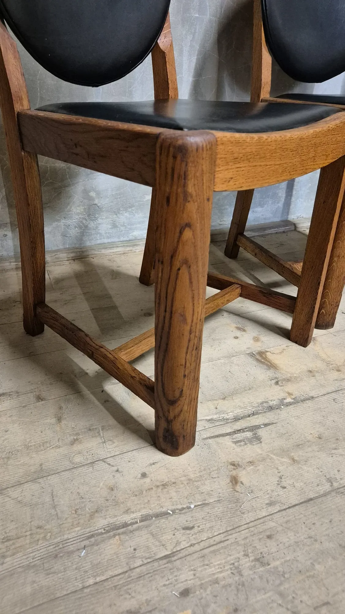 Set of four vintage wooden dining chairs with black leather upholstery, 85 × 45 × 45 cm