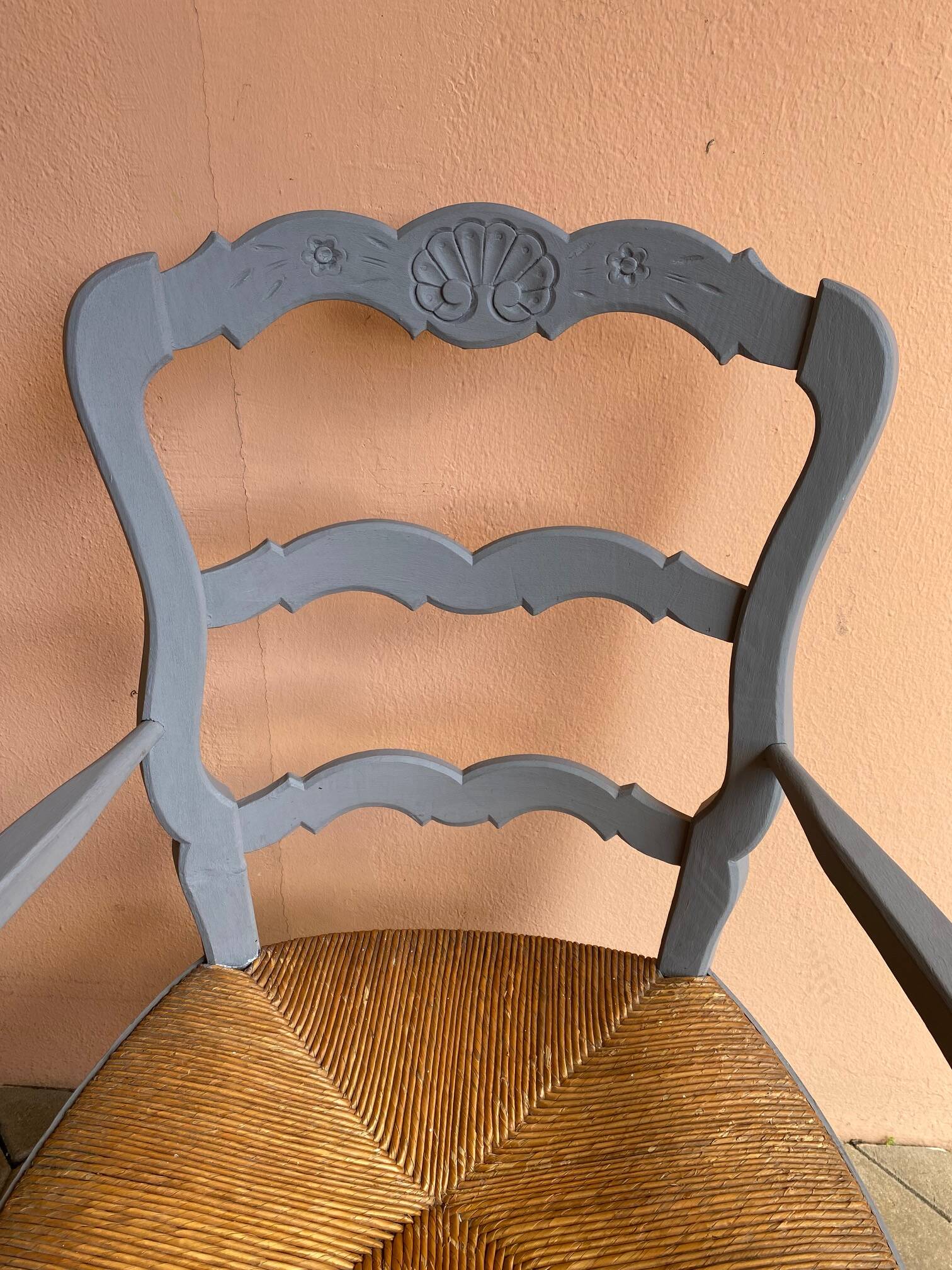 Provencal style straw armchair with gray blue patina armrests
