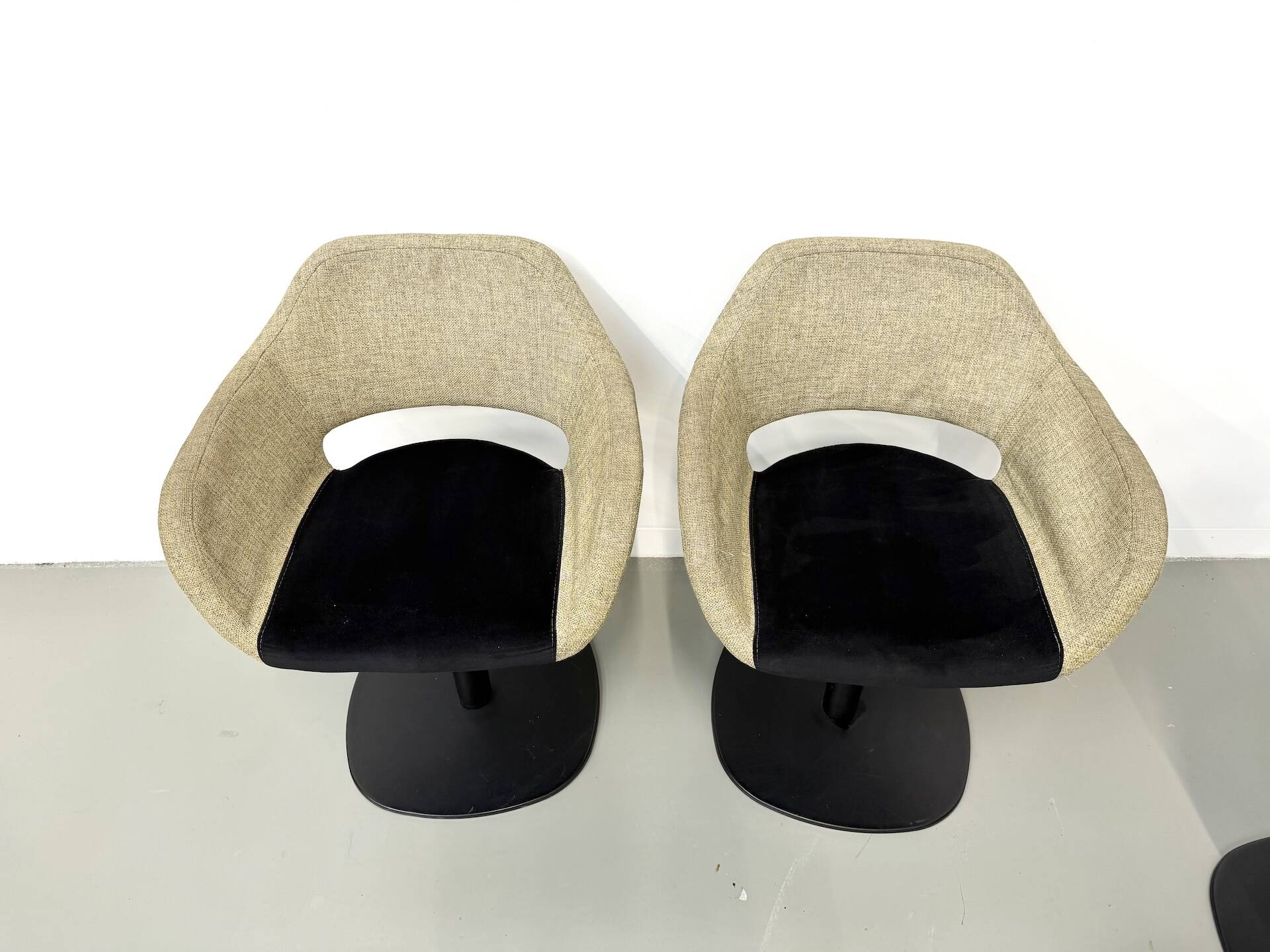 Series of six swivel chairs with an organic shell, patterned fabric and base.