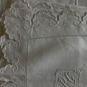 Pair of 19th-century linen pillowcases embroidered with scallops.