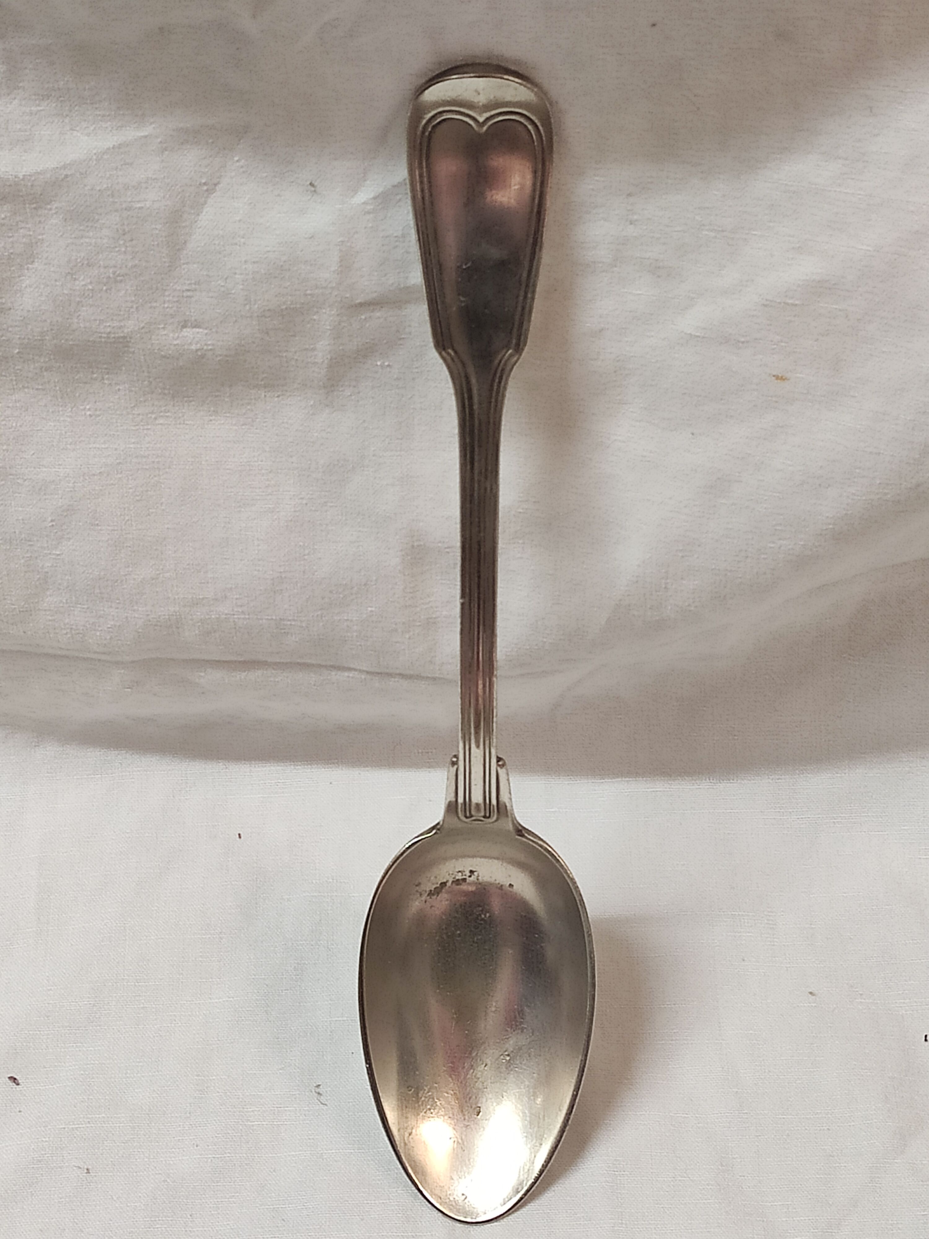 Serving spoon, silver metal.