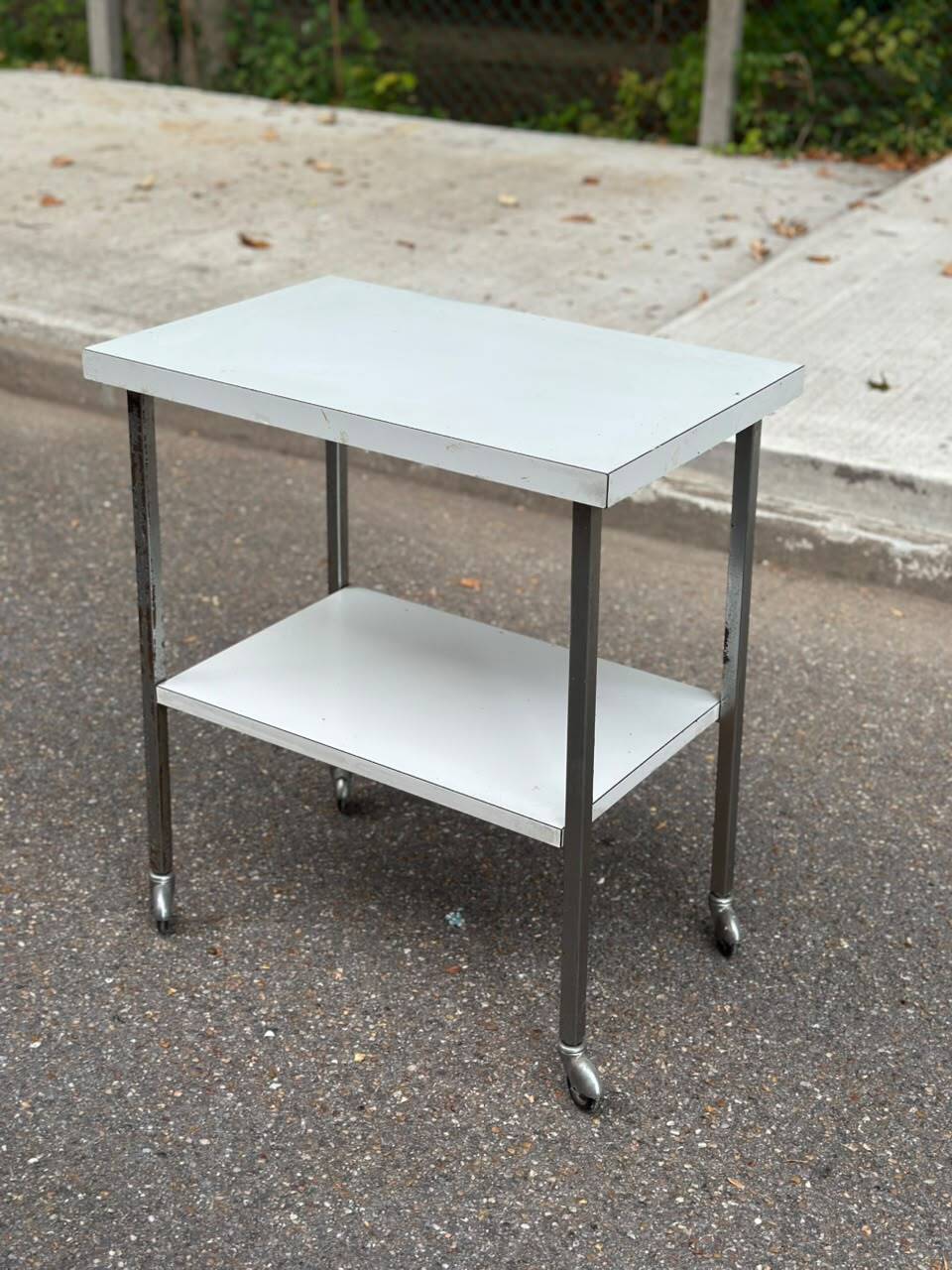 Rolling dessert trolley with 2 white formica shelves and steel, 1980.