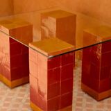 Modern coffee table in burgundy zellige with a tempered glass top.